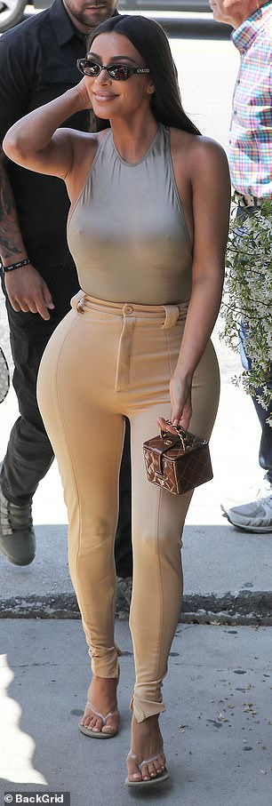 The 38-year-old reality star opted to go braless in a skintight taupe bodysuit