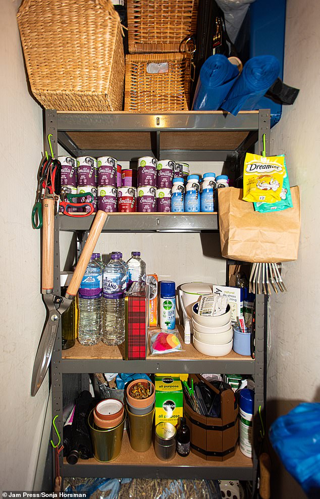 The cat lover spends roughly £400 a month on caring for her cats out of her own pocket, which makes up to around £40,000 over the years (pictured cat food in storage at her home)