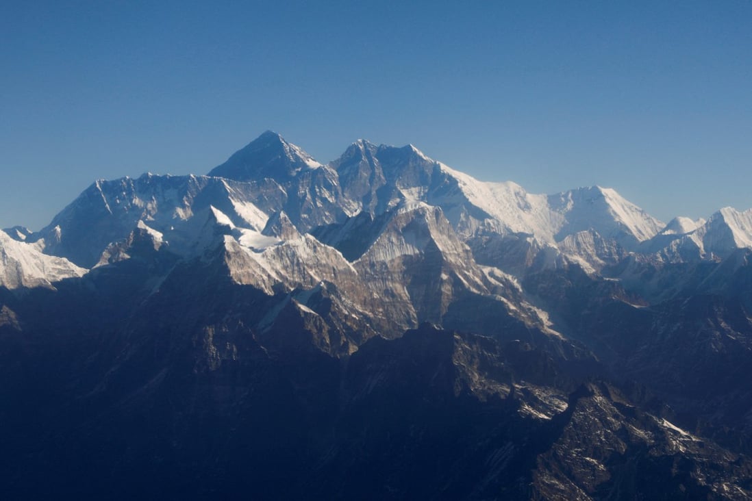 Mount Everest and other Himalayan peaks are seen through an aircraft window during a flight over Nepal. Photo: Reuters